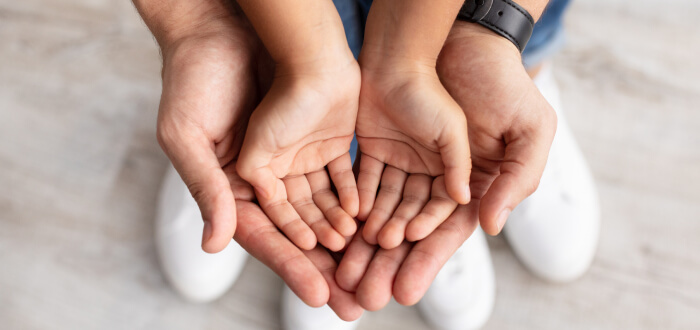 A father and a daughter holding hands