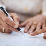 Woman signing prenuptial agreement